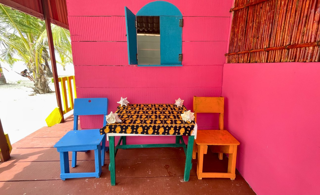 Brightly colored private terrace of a traditional wooden cabin on Chichime Island, San Blas, Panama- one of the charming accommodations on San Blas Tours from Panama City