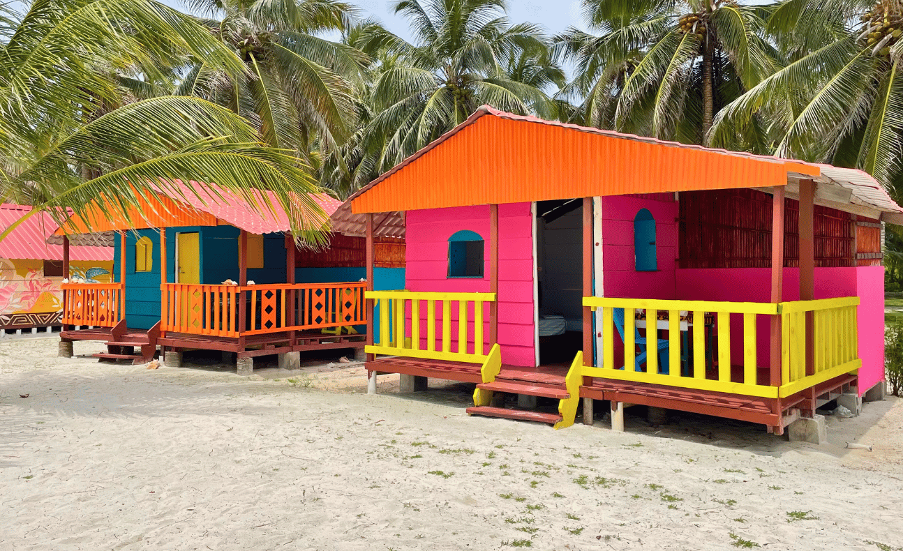 Row of colorful rustic beachfront cabins on Chichime Island, San Blas Islands, Panama – a blissful island holiday from Panama City.