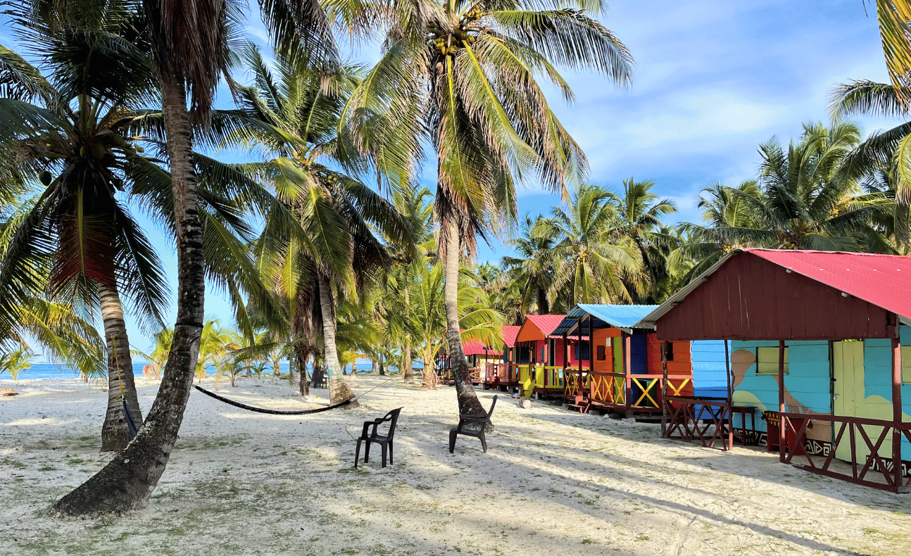Row of colorful beachfront cabins on Chichime Island, San Blas, Panama – a serene getaway destination on a San Blas Tour from Panama City
